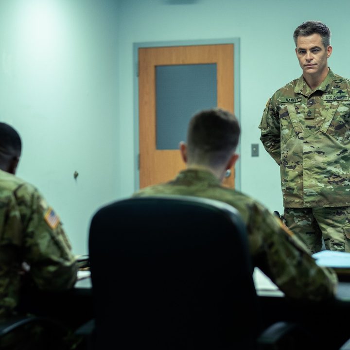 Chris Pine stands in uniform in a scene from The Contractor.