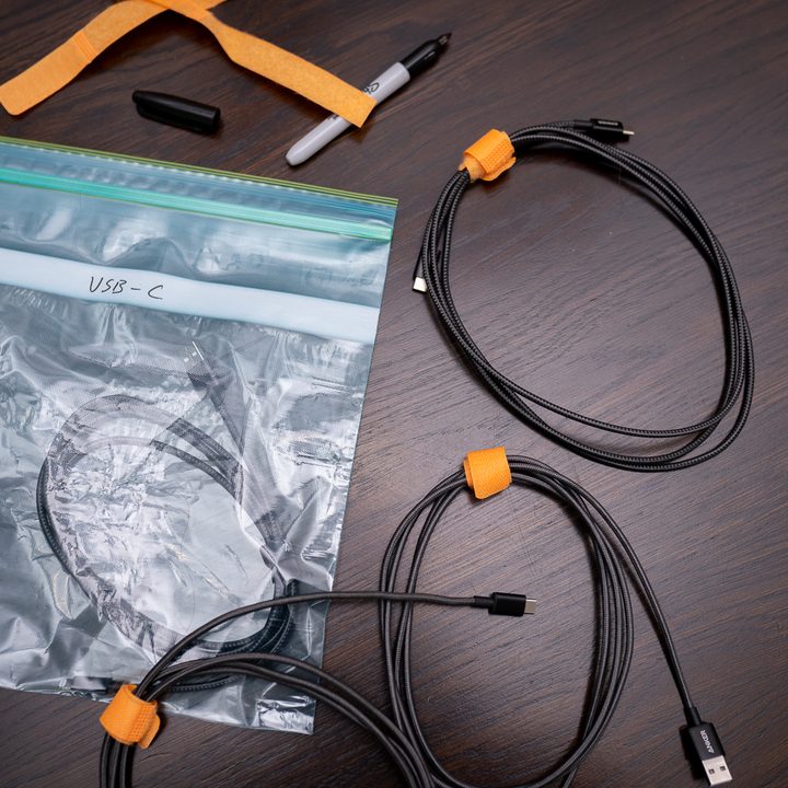 A collection of wrapped cables on a table near a plastic bag.