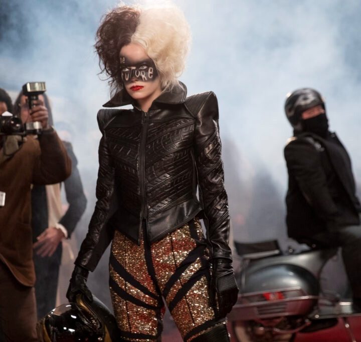 Cruella poses in a motorcycle jacket in Cruella.