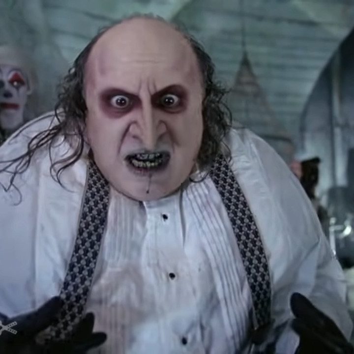 The Penguin looks on in disbelief in his sewer lair in Batman Returns.