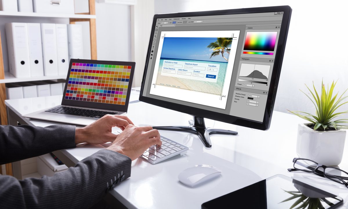 A designer editing a photo (Photoshop) via an image editing program on a PC.