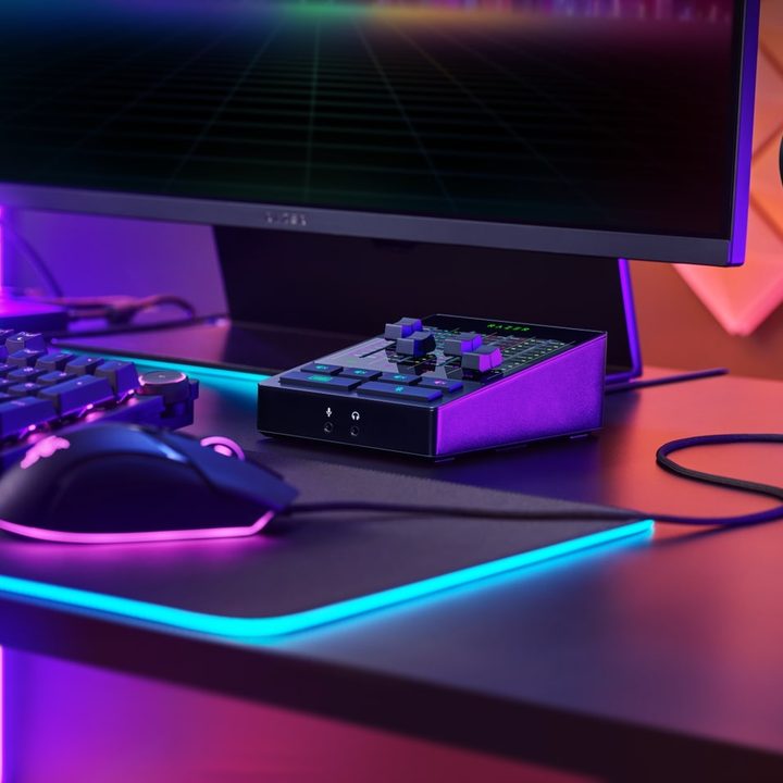 The Razer Audio Mixer sits on a desktop amid a monitor, keyboard, and mouse..