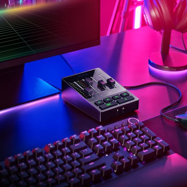 The Razer Audio Mixer sits on a desktop near a monitor, keyboard, and mouse.