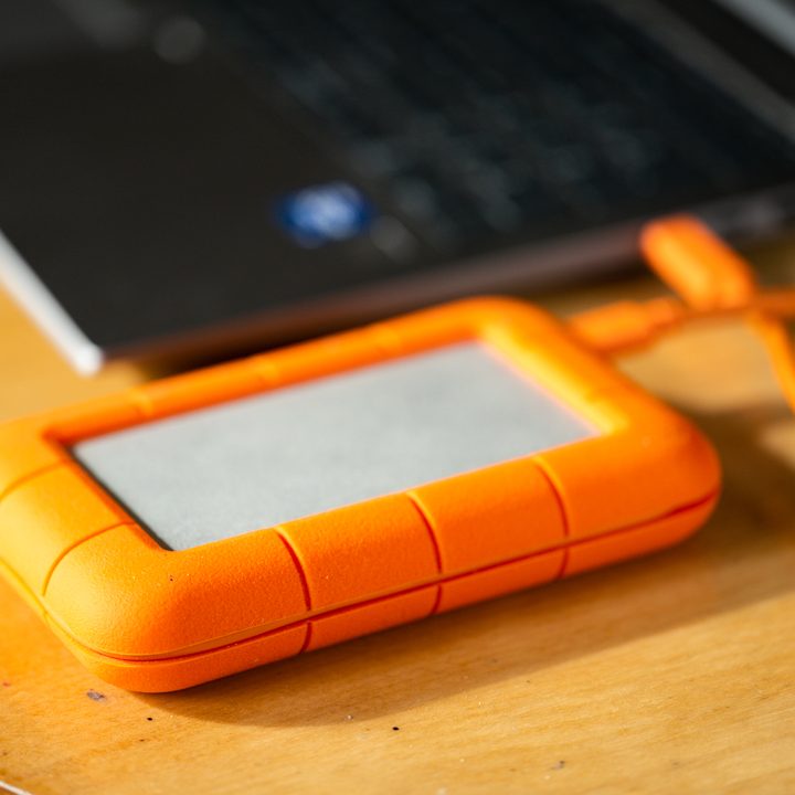 LaCie external hard drive next to a laptop computer.