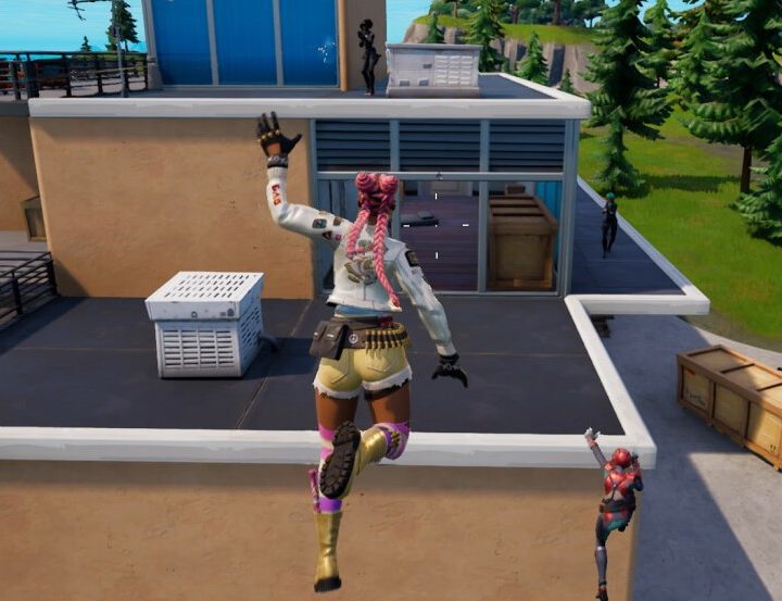 Character jumping toward a ledge in Fortnite.