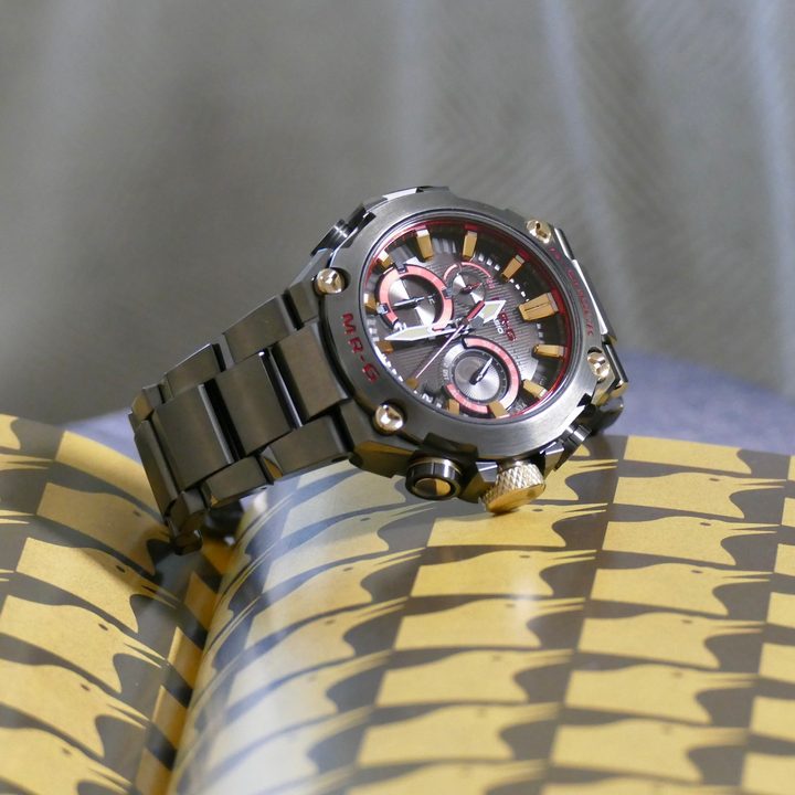 The G-Shock MRG-B2000B rest on a book.