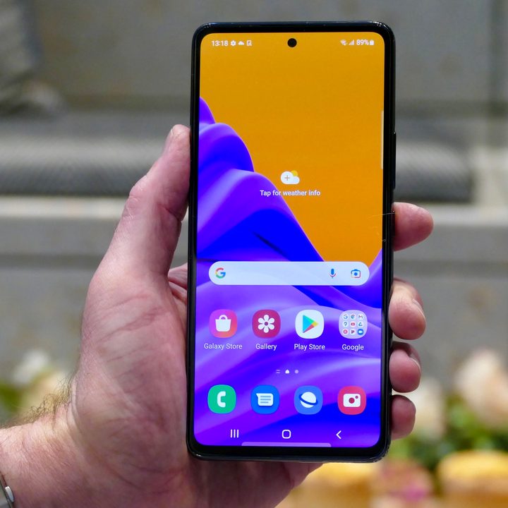 A hand holds the Samsung Galaxy A53 with the 5G screen showing.