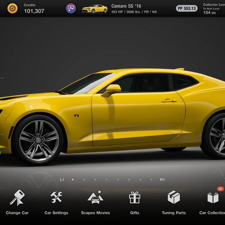 A yellow Camaro sits in the garage in Gran Turismo 7.