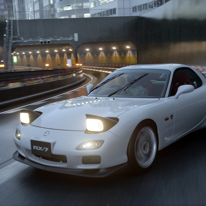A Mazda RX-7 drifts in the rain on a Tokyo expressway in Gran Turismo 7.