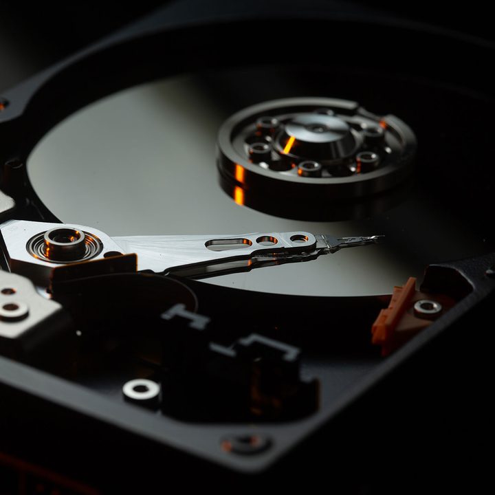 A hard disk drive that showcases the inner components.