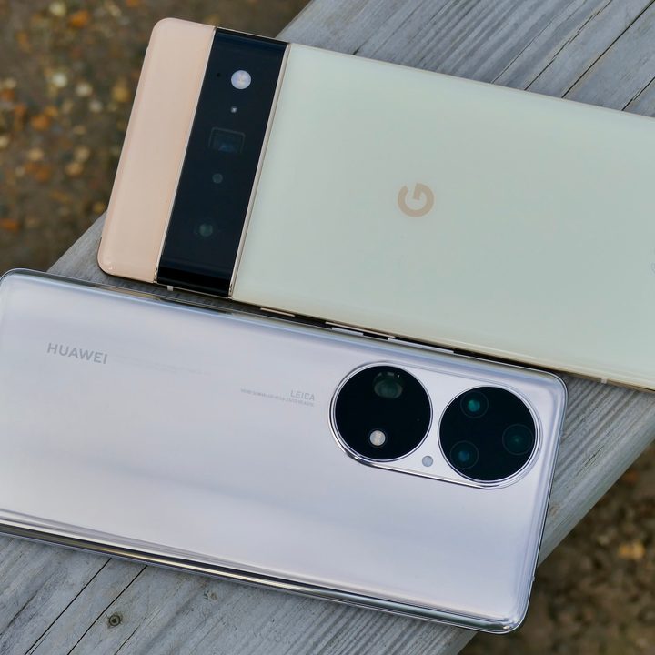 The Huawei P50 Pro and Pixel 6 Pro sit on a plank with their rear panels visible.