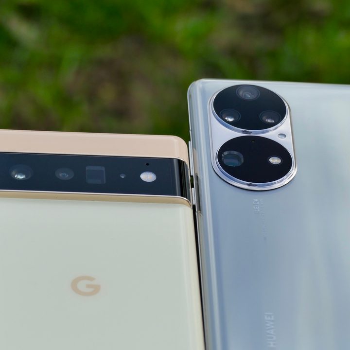 The Huawei P50 Pro and Pixel 6 Pro sit on a plank with their camera modules visible.