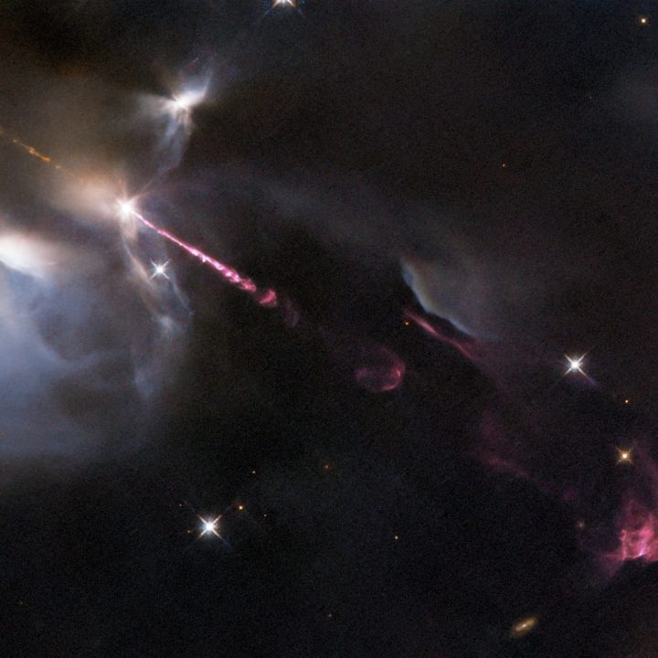 An energetic outburst from an infant star streaks across this image from the NASA/ESA Hubble Space Telescope.