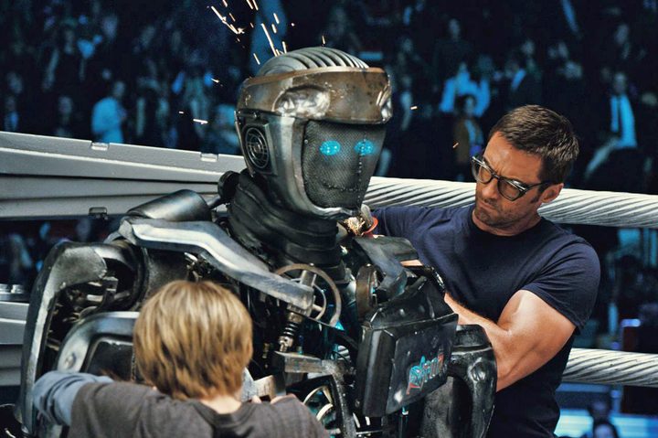 Hugh Jackman repairing a robot boxer in 2011's Real Steel