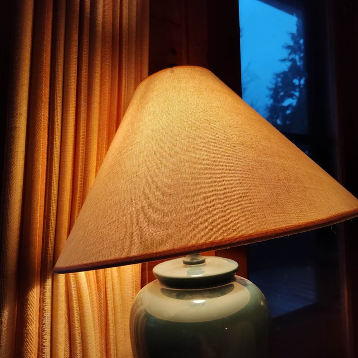 A glowing lamp in a dark room.