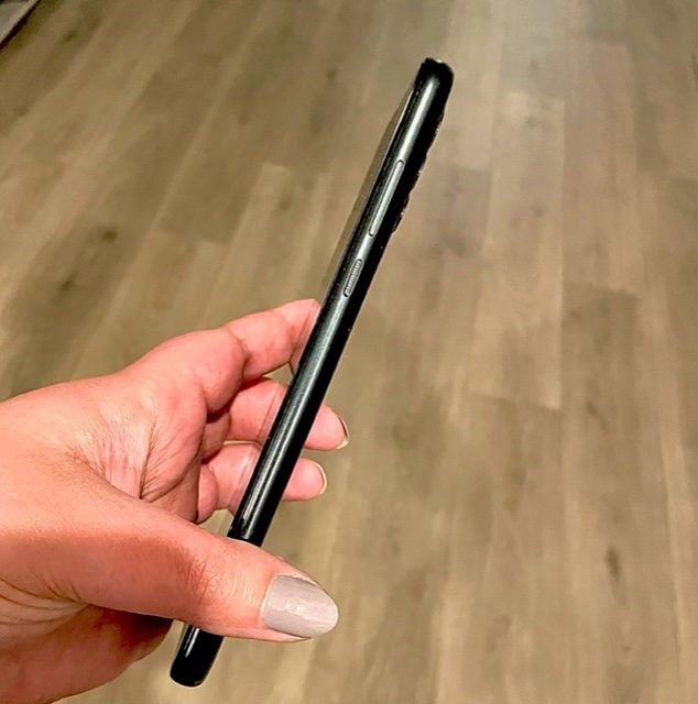 A side view of the Moto G Power 2022 being held in a hand.