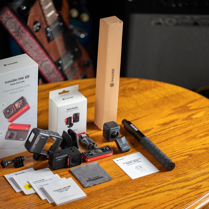 Insta360 One RS with accessories and packaging on a table.