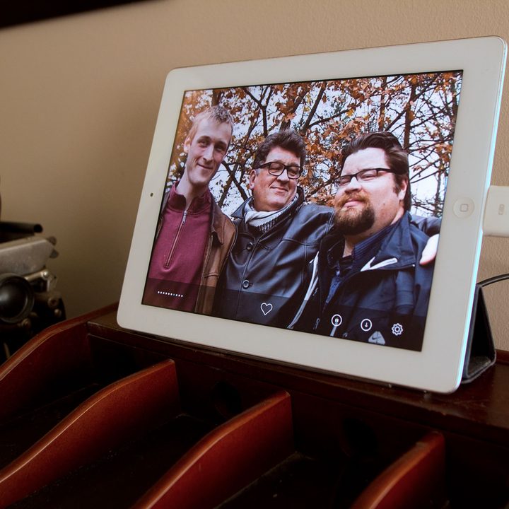 An old iPad being used as a picture frame.