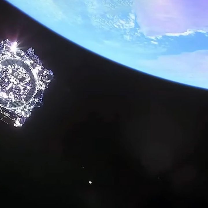 The James Webb Space Telescope hovers above Earth.