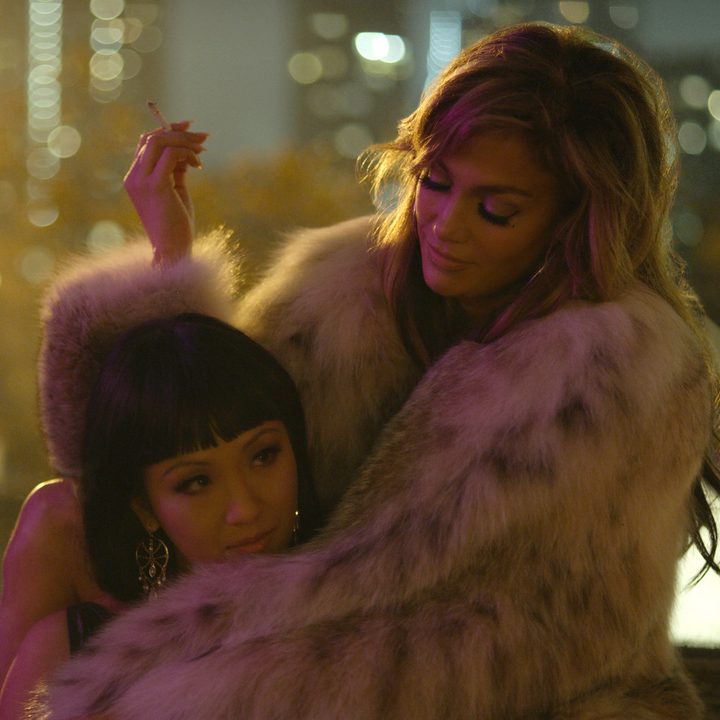 Constance Wu sits with Jennifer Lopez in Hustlers.