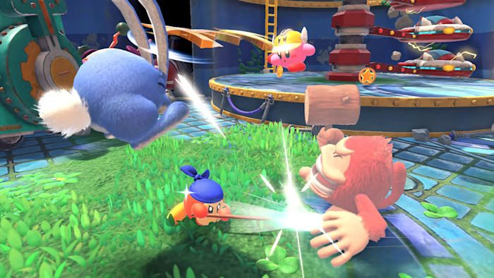 Kirby and Waddle Dee fight enemies in Kirby and the Forgotten Land.