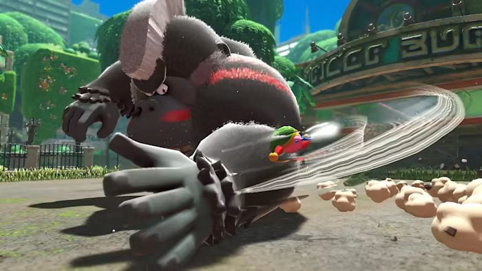 A gorilla swats Kirby in Kirby and the Forgotten Land.