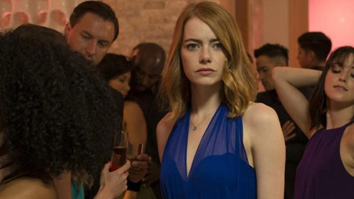Mia stares ahead in a crowded dance party in La La Land.