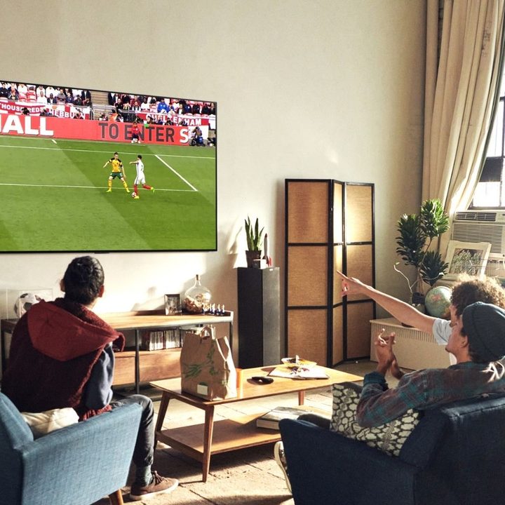 Group watching sports on 48-inch LG C1 4K TV.