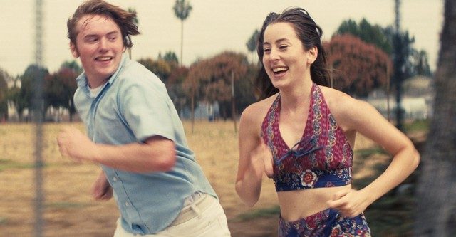 Alana and Gary run in Licorice Pizza.