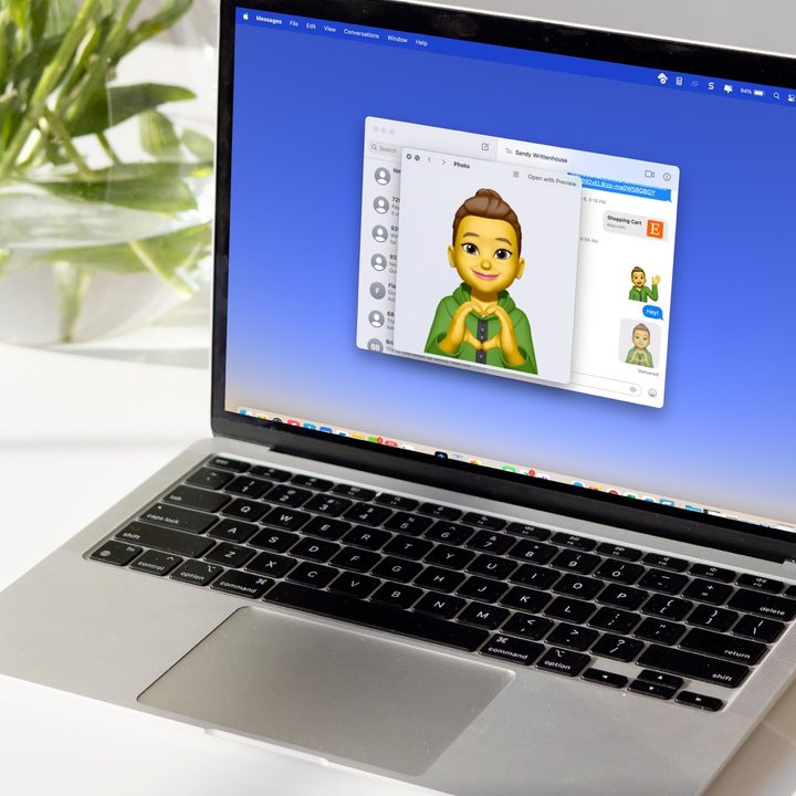 The display on a MacBook shows a Memoji in Messages.