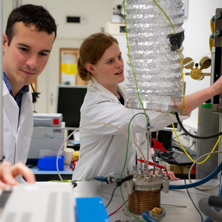 ESA research fellow Alexandre Meurisse and Beth Lomax of the University of Glasgow producing oxygen and metal out of simulated moondust inside ESA's Materials and Electrical Components Laboratory.