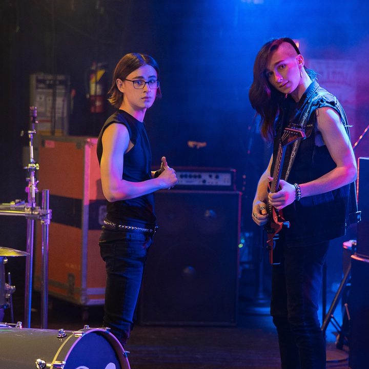 Jaden Martell and Aidan Greensmith tune up before a performance in a scene from Metal Lords.