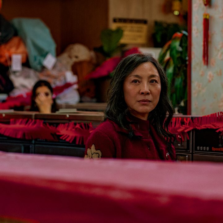 Michelle Yeoh stands in a laundromat in Everything Everywhere All At Once.