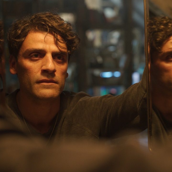 Oscar Isaac stares into a mirror in a scene from Moon Knight.