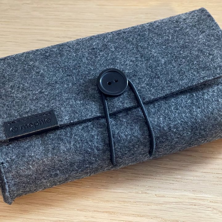 The Mophie 3-in-1 MagSafe travel charger case on a table.