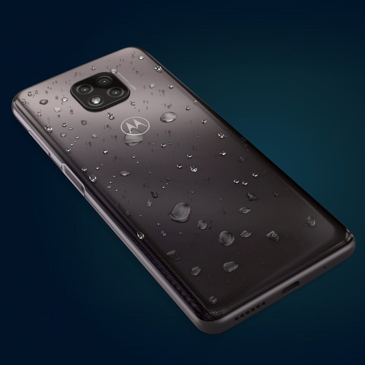 The rear panel of the Moto G Power (2021) with water droplets on it against a blue background.