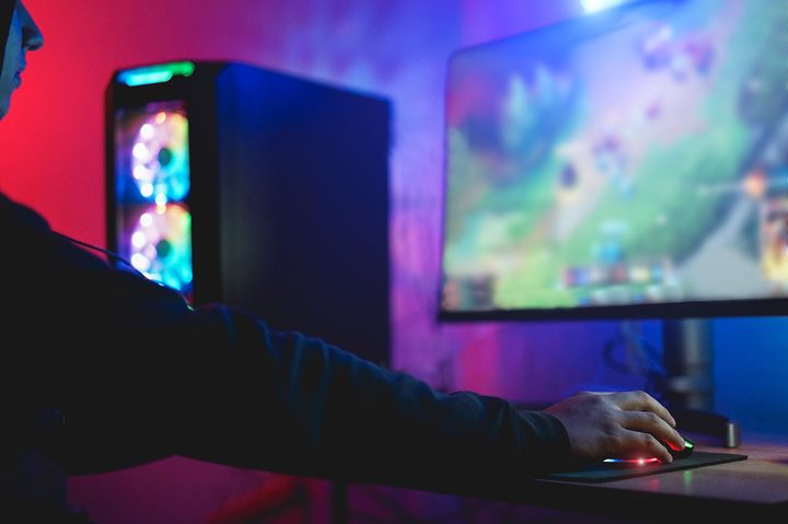 A gamer plays at a PC setup.