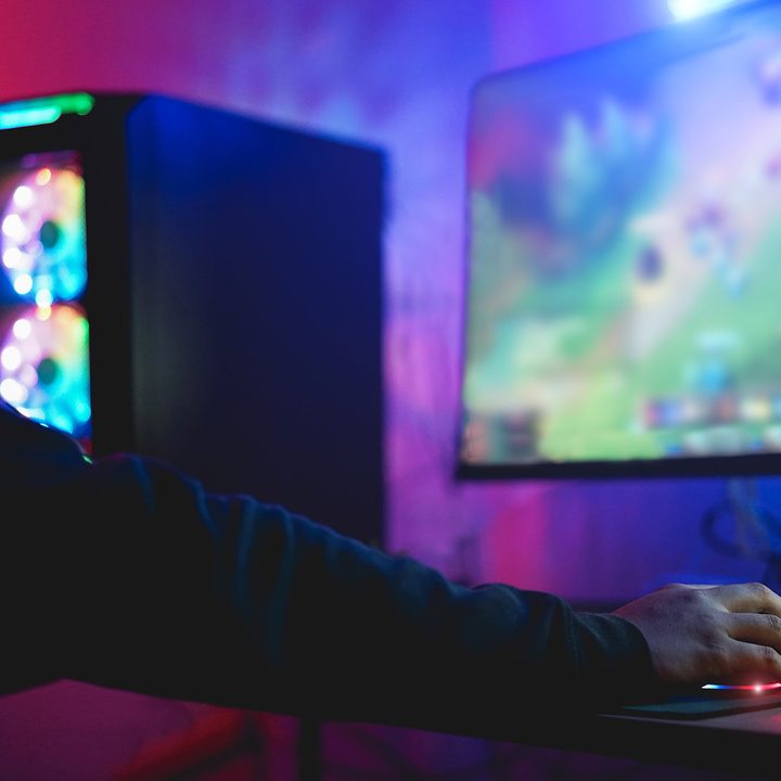 A gamer plays at a PC setup.