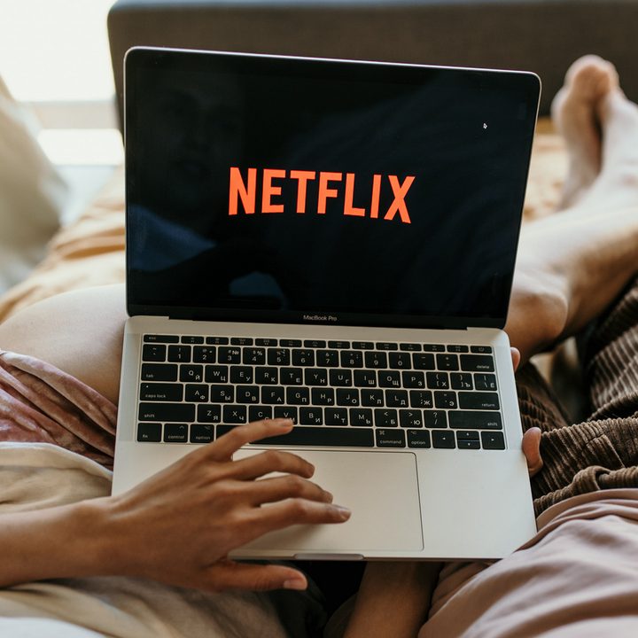A couple watching Netflix on a laptop.