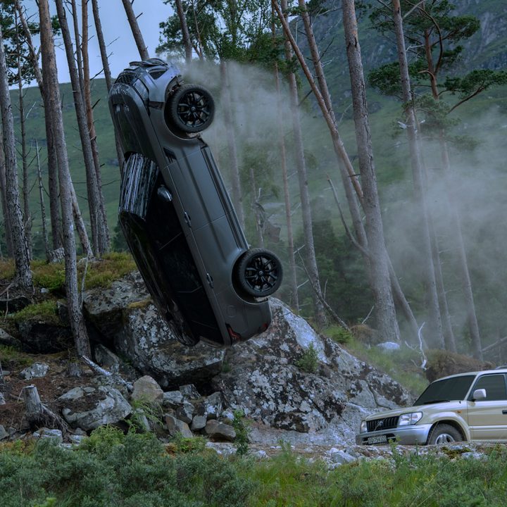 A Land Rover flips over James Bond's Land Cruiser in a scene from No Time To Die.