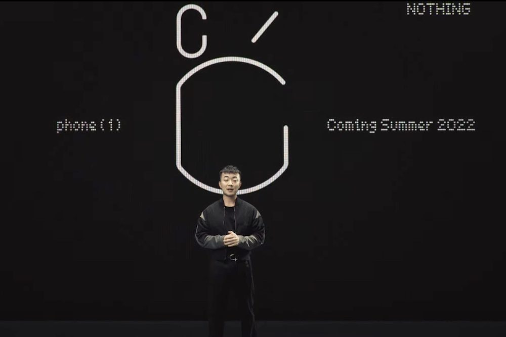 Nothing founder Carl Pei stands in front of the Nothing Phone 1 teaser.