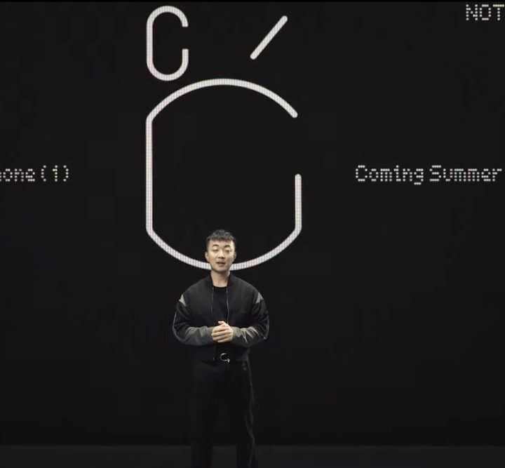 Carl Pei stands in front of the Nothing Phone 1 teaser at the announcement event.