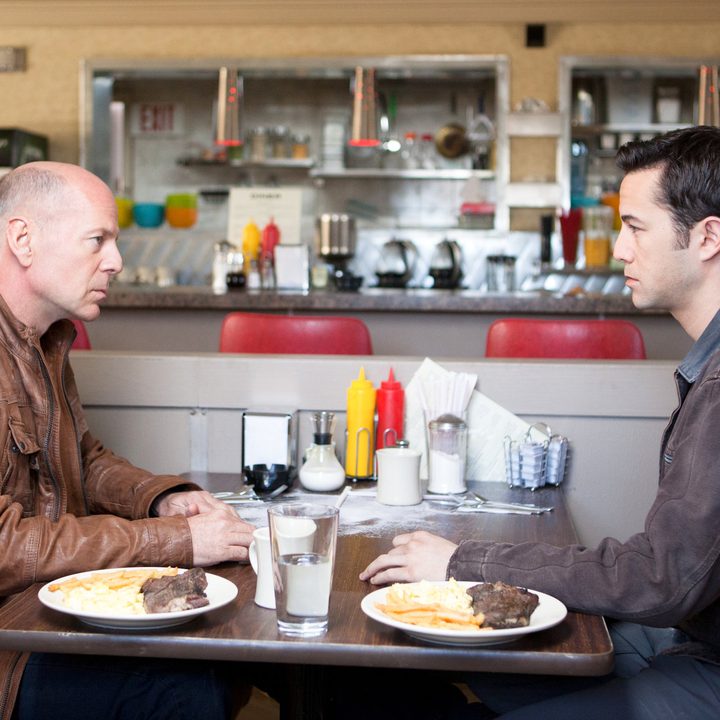 Bruce Willis and Joseph Gordon-Levitt face off a diner in Looper.