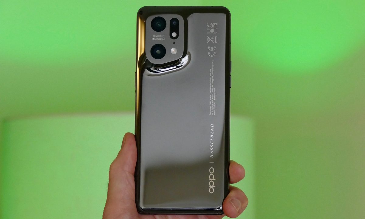 Oppo Find X5 Pro held in hand seen from the back.