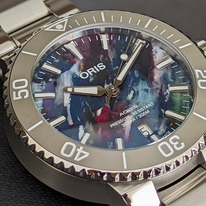 A close-up of the Oris Aquis Date Upcycle watch's dial.
