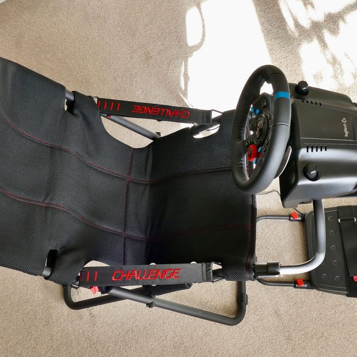 The PlaySeat Challenge and Logitech G29 steering wheel seen from the top down.