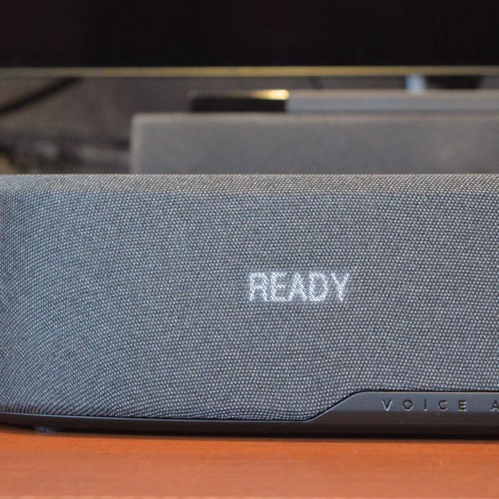 View of the OLED display screen behind the grille of the Polk MagniFi Mini AX soundbar.