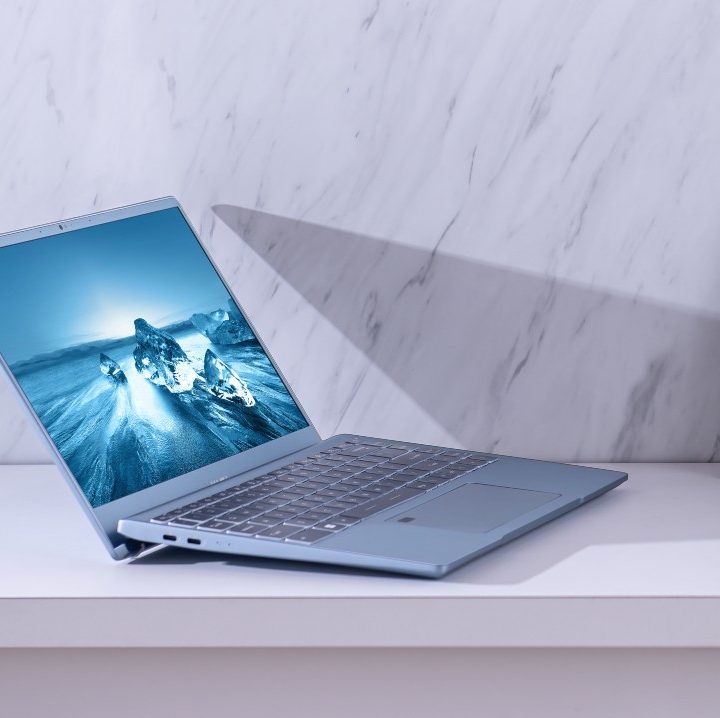 MSI's Prestige laptop on a table against a wall.