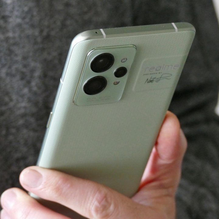 The Realme GT 2 Pro held in one hand and seen from the back.