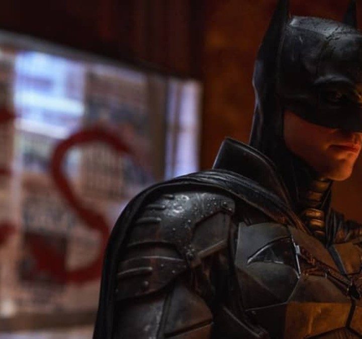 Batman surveys a crime scene in The Batman.